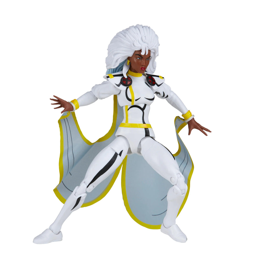 
                  
                    A 6-inch Marvel Legends Series X-Men Storm action figure in a classic white costume, accompanied by alternate hands with crackling electrical energy FX accessories, all contained in a '90s video cassette-inspired packaging.
                  
                