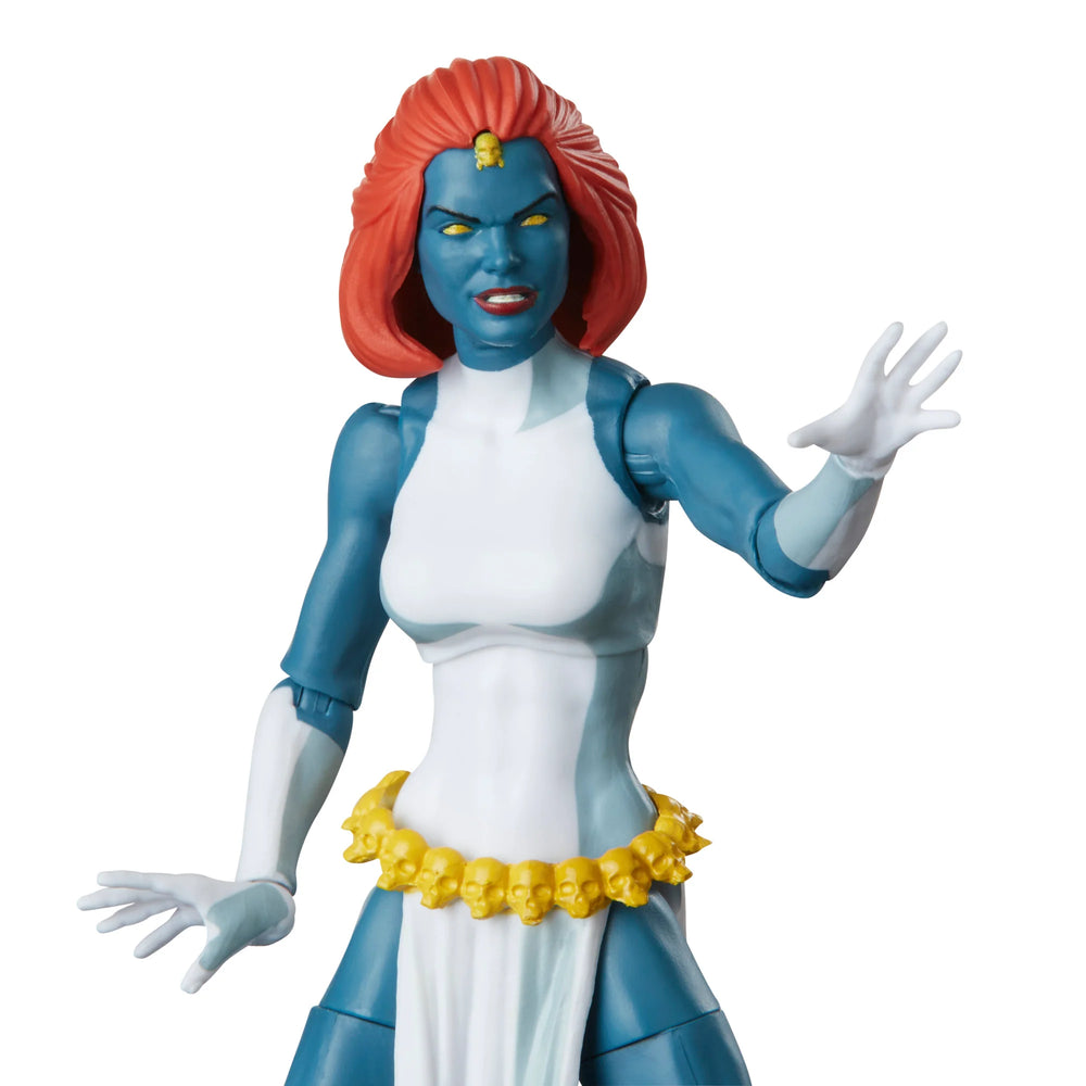 
                  
                    A 6-inch Marvel Legends Series X-Men Marvel's Mystique action figure with blue skin and yellow eyes, featuring accessories such as alternate hands, weapons, and a Baby Nightcrawler figure, all presented in a '90s video cassette-inspired packaging.
                  
                