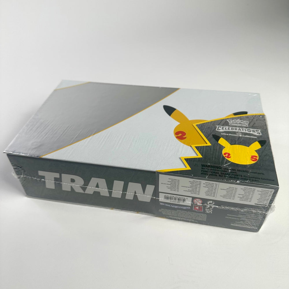 
                  
                    Pokemon Celebrations Ultra-Premium Collection Box featuring two commemorative metal cards, a gold Pikachu V, a gold Poké Ball, an enamel pin, an anniversary coin, and multiple Pokemon booster packs.
                  
                